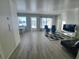 a living room with a couch and a flat screen tv at LENA - Brand new apartment - Modern & Cozy in Närpes - Built in 2023 in Närpiö