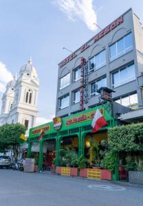 a building with a restaurant in front of it at Hotel El Meson in La Dorada