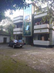 a car parked in front of a building at Syed monjil in Kamālpur