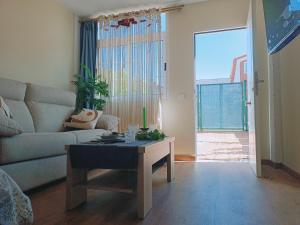 a living room with a couch and a coffee table at SANTANDER-LIENCRES VILLA PERAL in Liencres