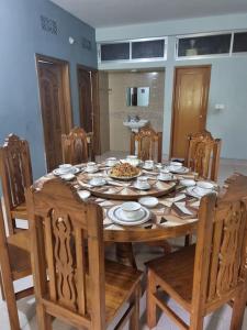 a wooden dining room table with chairs and a table and chairsktop at Syed monjil 