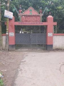 a red gate with a sign in front of it at Syed monjil 