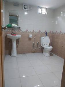 a bathroom with a toilet and a sink at Syed monjil 