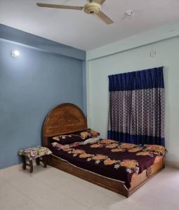 a bedroom with a bed and a ceiling fan at Syed monjil in Kamālpur +6 photos