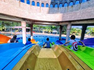 a group of children on a water slide at a water park at Melaka Top Largest Waterpark Resort - By YouBNB Homestay Melaka in Melaka