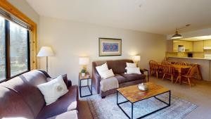 a living room with a couch and a table at Powderhorn by Whistler Premier in Whistler