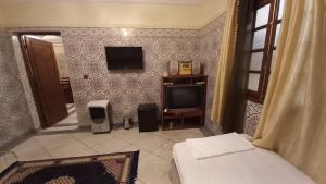 a bedroom with a tv and a bed and speakers at Stay with low budget in Marrakesh