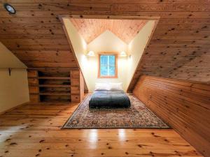 a room with a bed in the middle of a attic at Wilderness Vista Retreat in Reed City
