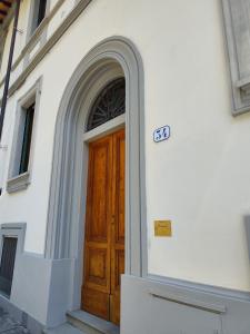 a building with a wooden door with a sign on it at Affittacamere Ramazzini in Florence