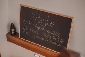 a chalkboard with writing on it on a wall at Apartmán Boženy Němcové in Polná