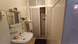 a white bathroom with a sink and a shower at Stay with low budget in Marrakesh
