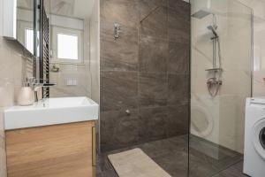 a bathroom with a shower with a sink and a toilet at Seaview apartments Glamour Vir - by TA Leut Agency in Vir +114 photos