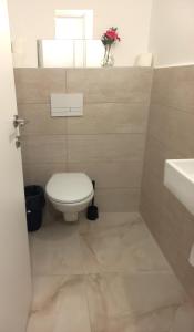 a bathroom with a toilet and a sink at Unique Luxurious New 4BR near Beach in Haifa