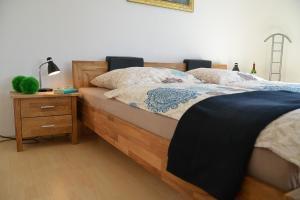 a bedroom with a bed and a night stand with a lamp at Sonnenhaus Ferienwohnungen in Traben-Trarbach