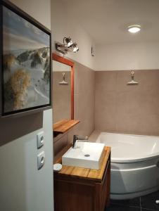 a bathroom with a tub and a sink and a bath tub at VILLA KB'HOME in Le Touquet-Paris-Plage