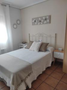 a bedroom with a large white bed in a room at Casa Rural La Tejeria in Villora