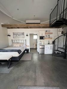a bedroom with a bed and a kitchen with stairs at Silo Suite 1 Pet Friendly- Near Zion National Park in La Verkin