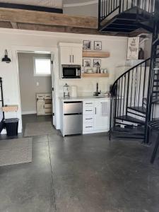 a kitchen with white cabinets and a staircase in a house at Silo Suite 1 Pet Friendly- Near Zion National Park in La Verkin