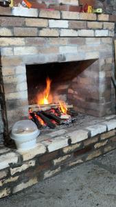 a brick oven with a fire in it at Chalet Bakhmaro in Chʼkhakoura