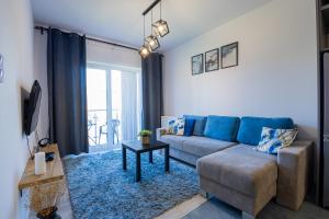 a living room with a couch and a table at Vip Apartament Wieniawskiego in Rzeszów