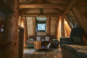 a living room with couches and a table in a cabin at Domček v pieninach . in Majere