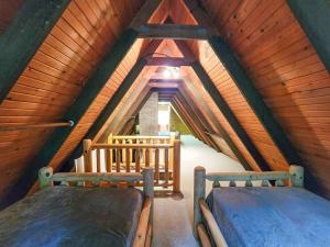 a bedroom with two beds in a attic at River's Edge Retreat in Evart