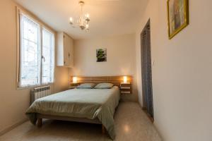 a bedroom with a bed and a large window at gite montreuil le henri 2 pers in Montreuil-le-Henri