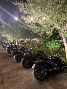 a row of motorcycles parked in a row at PARADISE Laguna Vain in Lezhë