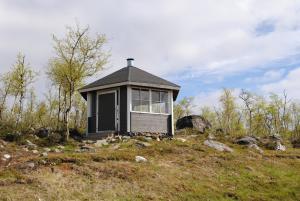 a small house on top of a hill at Haltinmaa Cottages in Kilpisjärvi