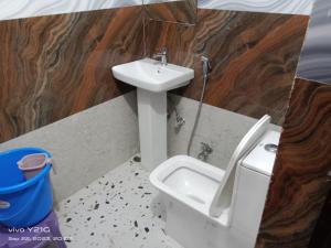 a bathroom with a sink and a toilet at Hotel vikram in Khajurāho