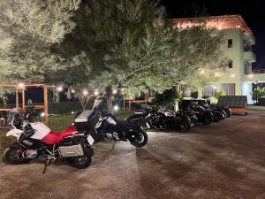 a row of motorcycles parked in front of a house at PARADISE Laguna Vain in Lezhë