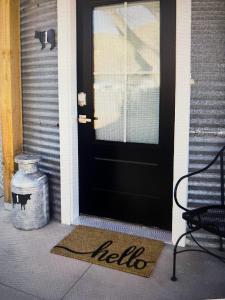 a black door with a hello sign on the front at Silo Suite 1 Pet Friendly- Near Zion National Park in La Verkin