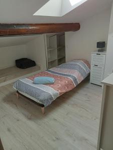 Cette petite chambre comprend un lit avec un cadre en bois. dans l'établissement T3 Duplex tout confort, à Toulouse