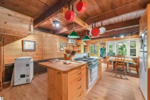 a kitchen with wooden walls and a wooden ceiling at Wildlife Haven Retreat in Evart