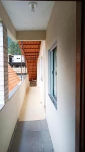 an empty hallway of a building with a window at pousada Montanhez flat in Caparaó Velho