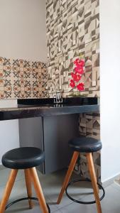 a bathroom with two stools and a counter with a sink at pousada Montanhez flat in Alto Caparao +12 photos