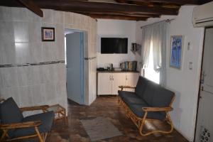 a living room with two chairs and a couch at 3 Anchors Aweigh in Hibberdene