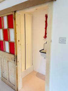 a room with a door and a cross on the wall at High spec studio cabin-Farnham centre in Farnham