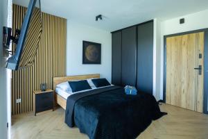 a bedroom with a bed and a wooden door at Vip Apartamenty in Rzeszów