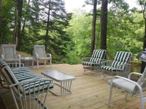 a group of chairs and a table on a deck at Timber Bend Retreat in Evart