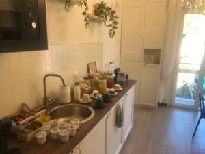 a kitchen with a sink and a counter top with food at Il Sogno di Contardi A Affittacamere in Monterosso al Mare