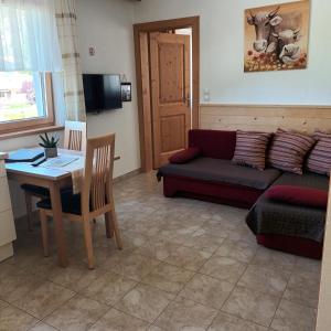 a living room with a couch and a table at Landhaus Zell in Längenfeld