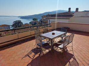 a table and chairs on a balcony with a view at Frontemare in Porto Santo Stefano