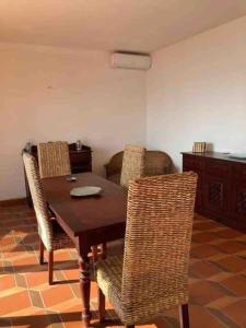 a dining room with a wooden table and chairs at Frontemare in Porto Santo Stefano