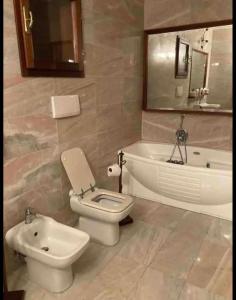 a bathroom with a toilet and a sink and a tub at Frontemare in Porto Santo Stefano