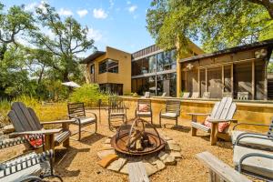 a yard with chairs and a fire pit in front of a house at The Haven by Lodgewell - Where serenity meets sanctuary in Austin