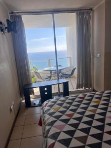 a bedroom with a bed and a view of the ocean at costa mansa 3200 in Coquimbo
