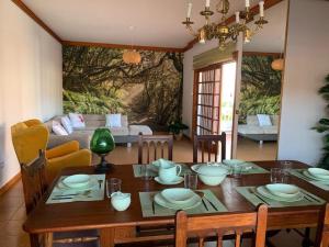 a dining room with a table and a couch at Chalet Tegueste Isla de Tenerife in Tegueste