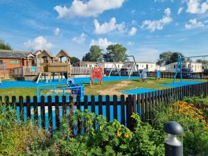 a playground with a seesaw at Modern Family Caravan with WiFi at Valley Farm, Clacton-on-Sea in Great Clacton