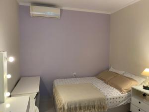 a small bedroom with a bed and a desk at Casa Zona Sul in Rio de Janeiro